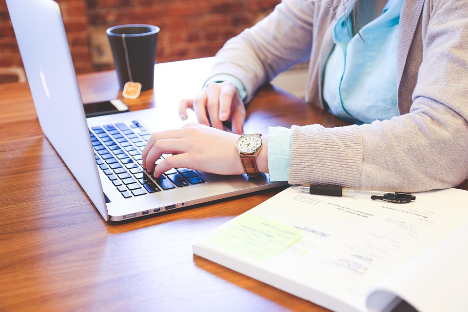 College student studying on laptop in off-campus apartment